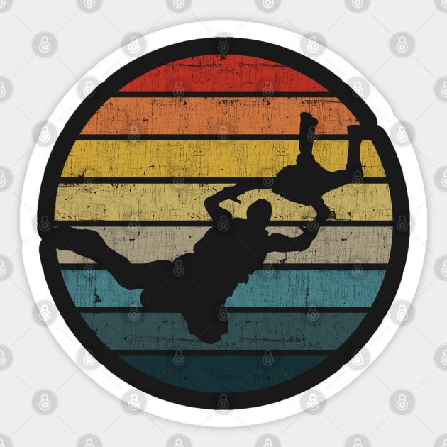 BASE jumping Silhouette On A Distressed Retro Sunset print Sticker by theodoros20